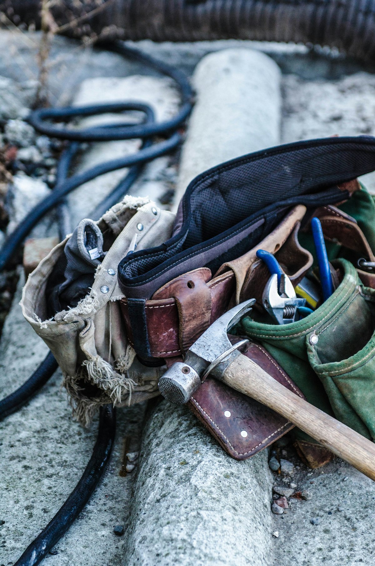 A plumber's tool belt with hammer and pliers